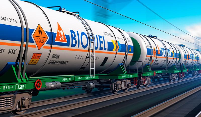 Fuel, oil and gas industry, ecology protection technology, logistics, cargo shipping and freight railroad transportation business concept: fast train with tankcars with biofuel with motion blur effect